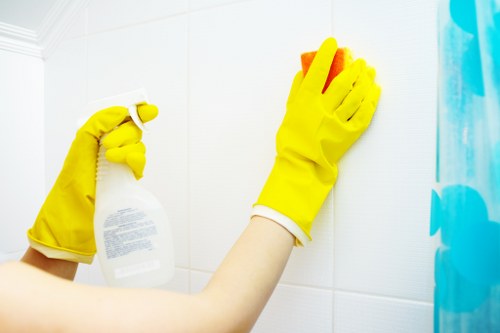 Applying oven cleaner to remove stubborn grime